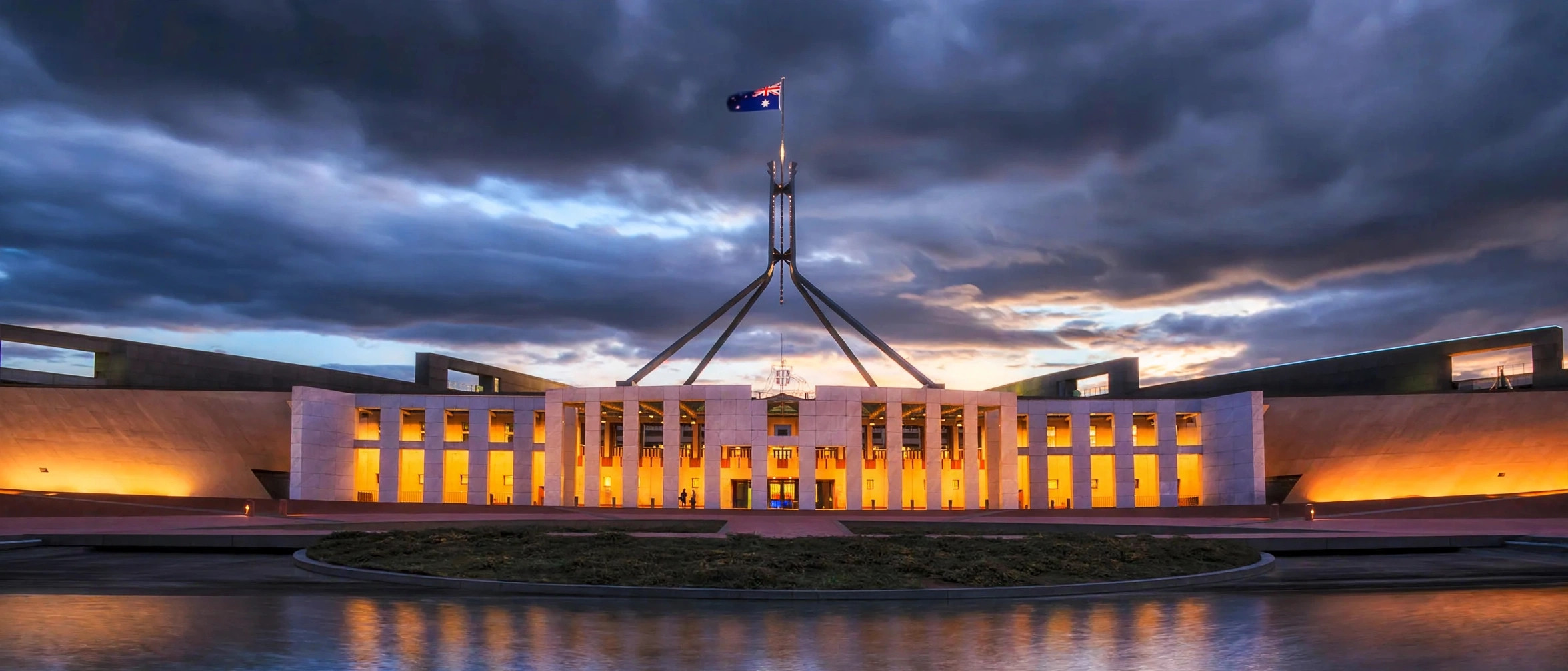 Altman Amodei Australian Senate inquiry — Australian Parliament House in Canberra at dusk