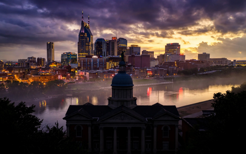 Nashville skyline at dusk with a historic courthouse dome in the foreground, representing the Bryan Seaver Dolly Parton estate legal battle in Nashville court
