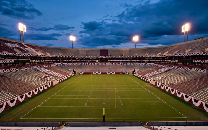 Empty college football stadium at dusk, article on the Marcel Reed doxxing incident