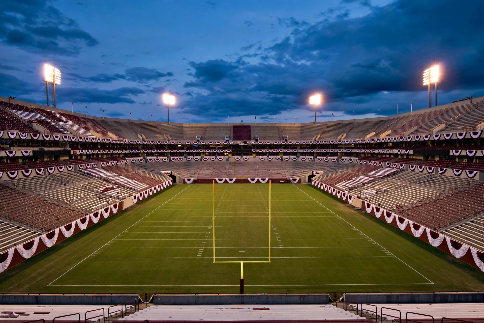 Empty college football stadium at dusk, article on the Marcel Reed doxxing incident