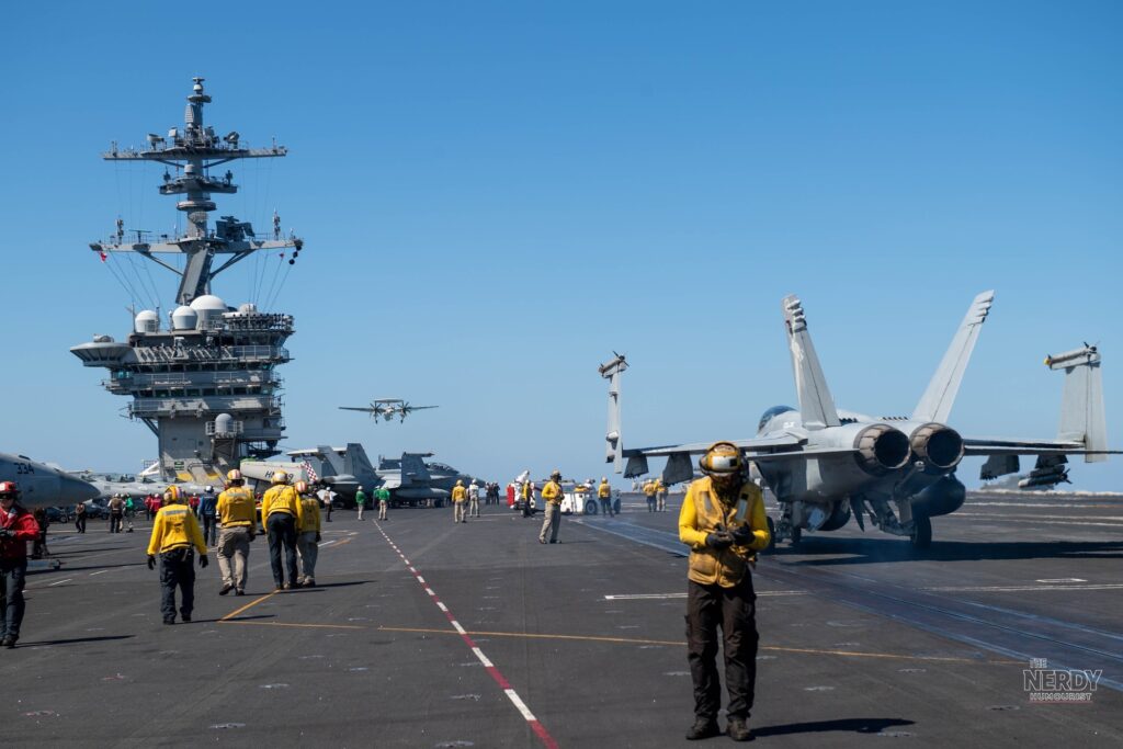 Flight deck operations aboard the USS Theodore Roosevelt, jets and crew on deck during the US Iran war aircraft carrier deployment