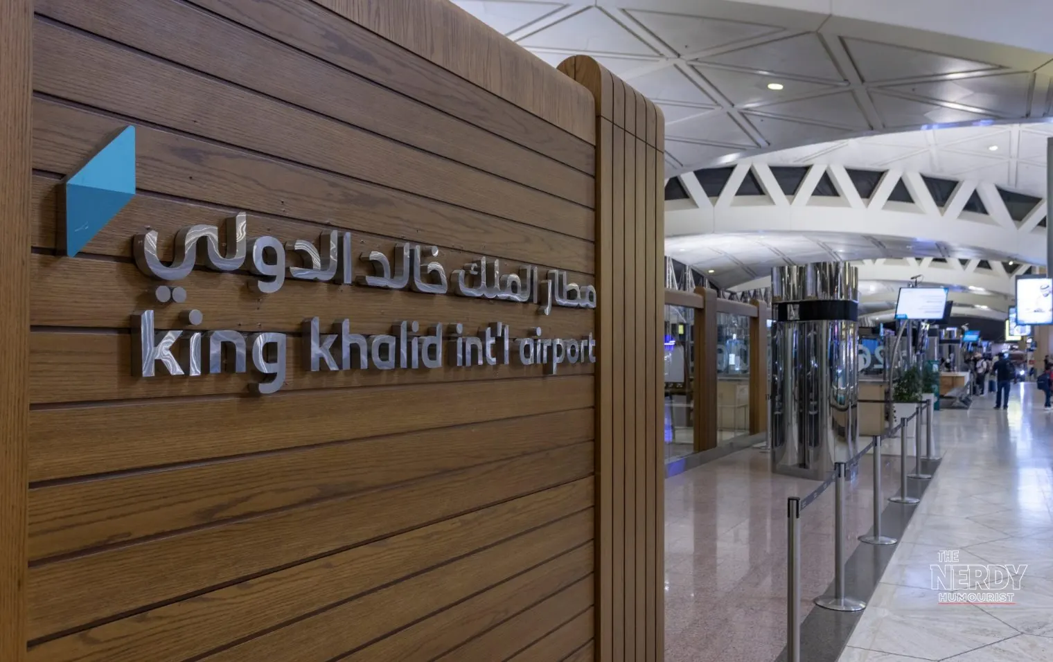 King Khalid International Airport sign in Riyadh — US staff leave Saudi Arabia