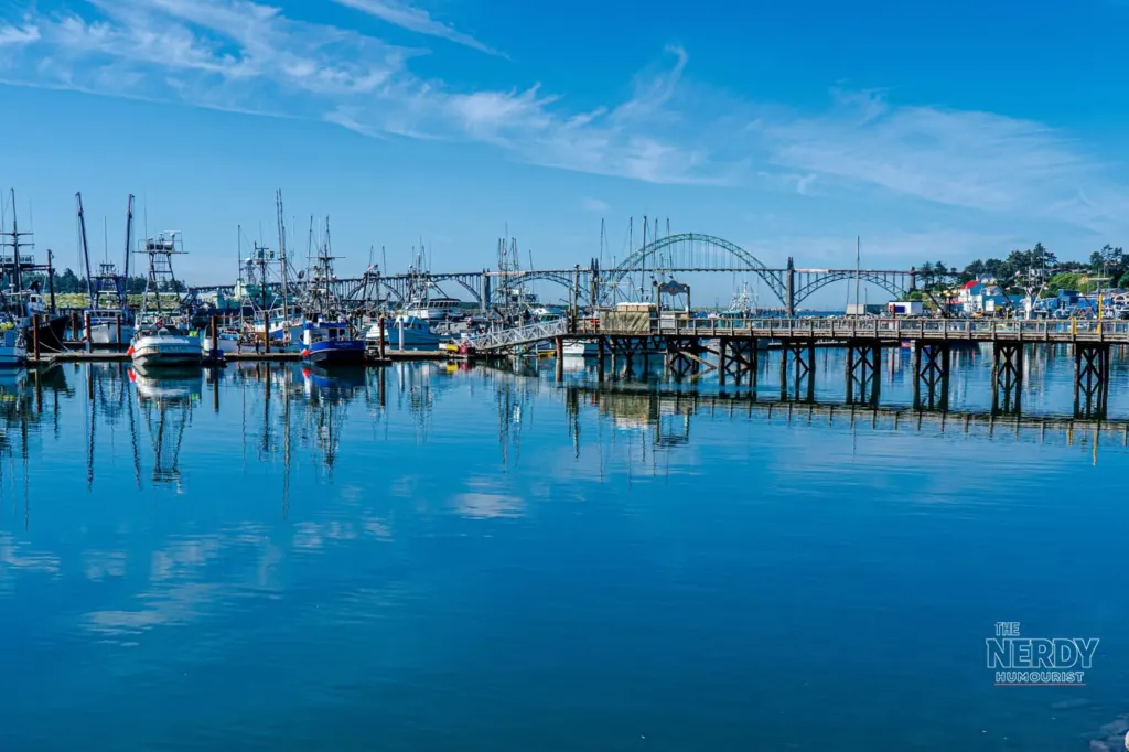 Newport Oregon bayfront with fishing boats and Yaquina Bay Bridge — Newport Oregon seafood plant fire