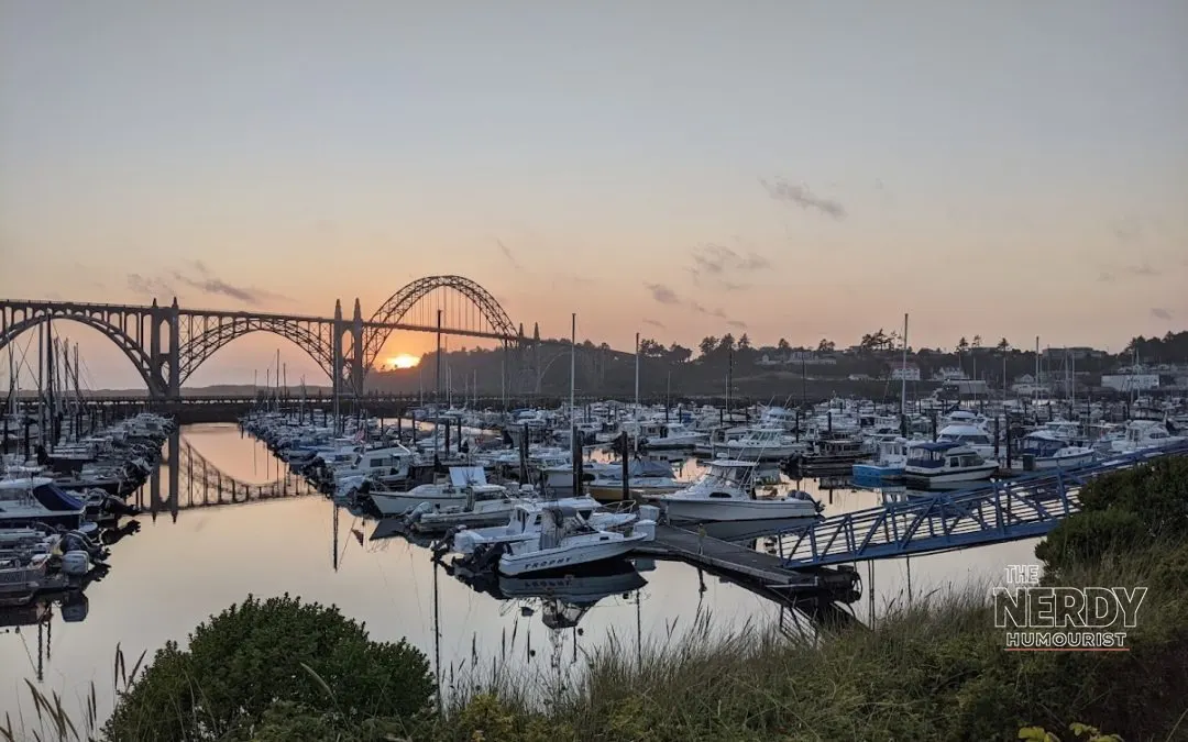 Newport Oregon marina at sunset with Yaquina Bay Bridge — Newport Oregon seafood plant fire