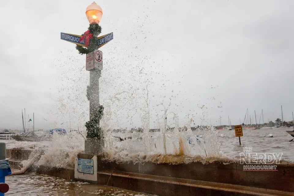 Waves crashing over a Newport Beach seawall during coastal flooding — California coastal flooding