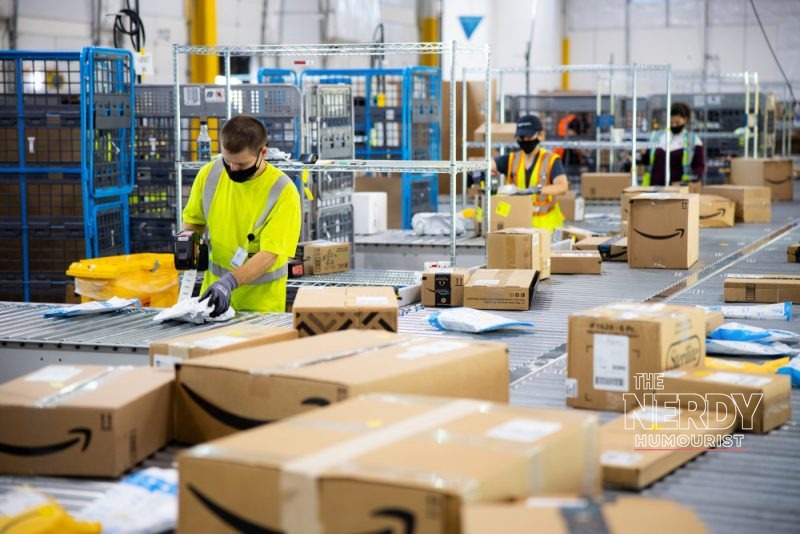 Amazon warehouse workers sorting packages — the Amazon layoffs 2026 cuts hit the Stores unit behind the main e-commerce site