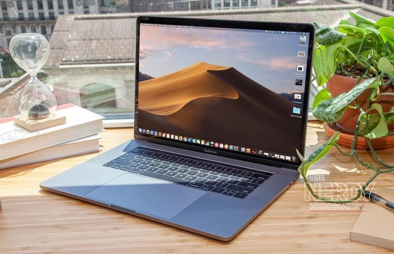 MacBook Pro on a wooden desk — the Apple macOS Full Disk Access AI agents announcement is the clearest sign platform owners treat AI agents as a new threat model