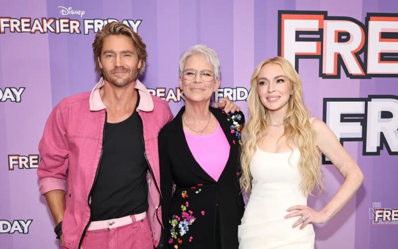 Lindsay Lohan poses at a red-carpet event; she marked Lindsay Lohan Mean Girls Day by recreating the iconic October 3 Mean Girls scene with director Mark Waters