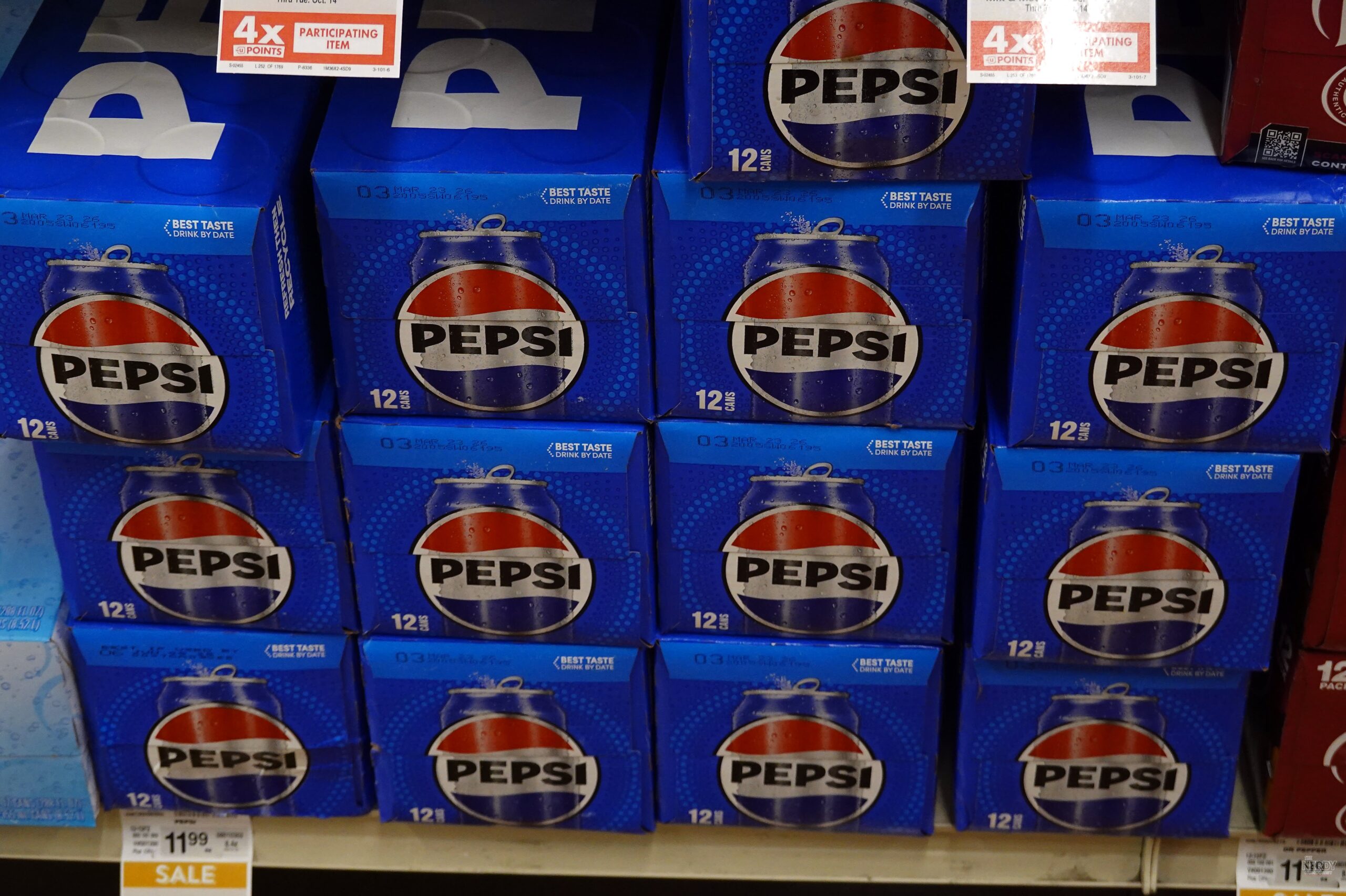 Pepsi 12-packs stacked on a store shelf — PepsiCo Q3 earnings flagged weaker North America beverage volumes
