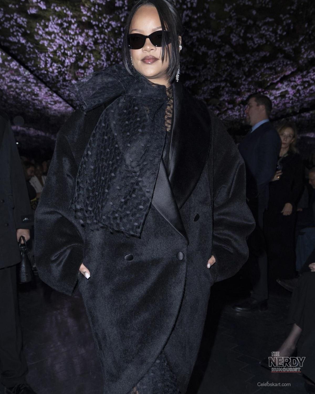 Rihanna attends a Dior show in Paris, at the center of the Rihanna EJ Johnson Dior Paris Fashion Week controversy