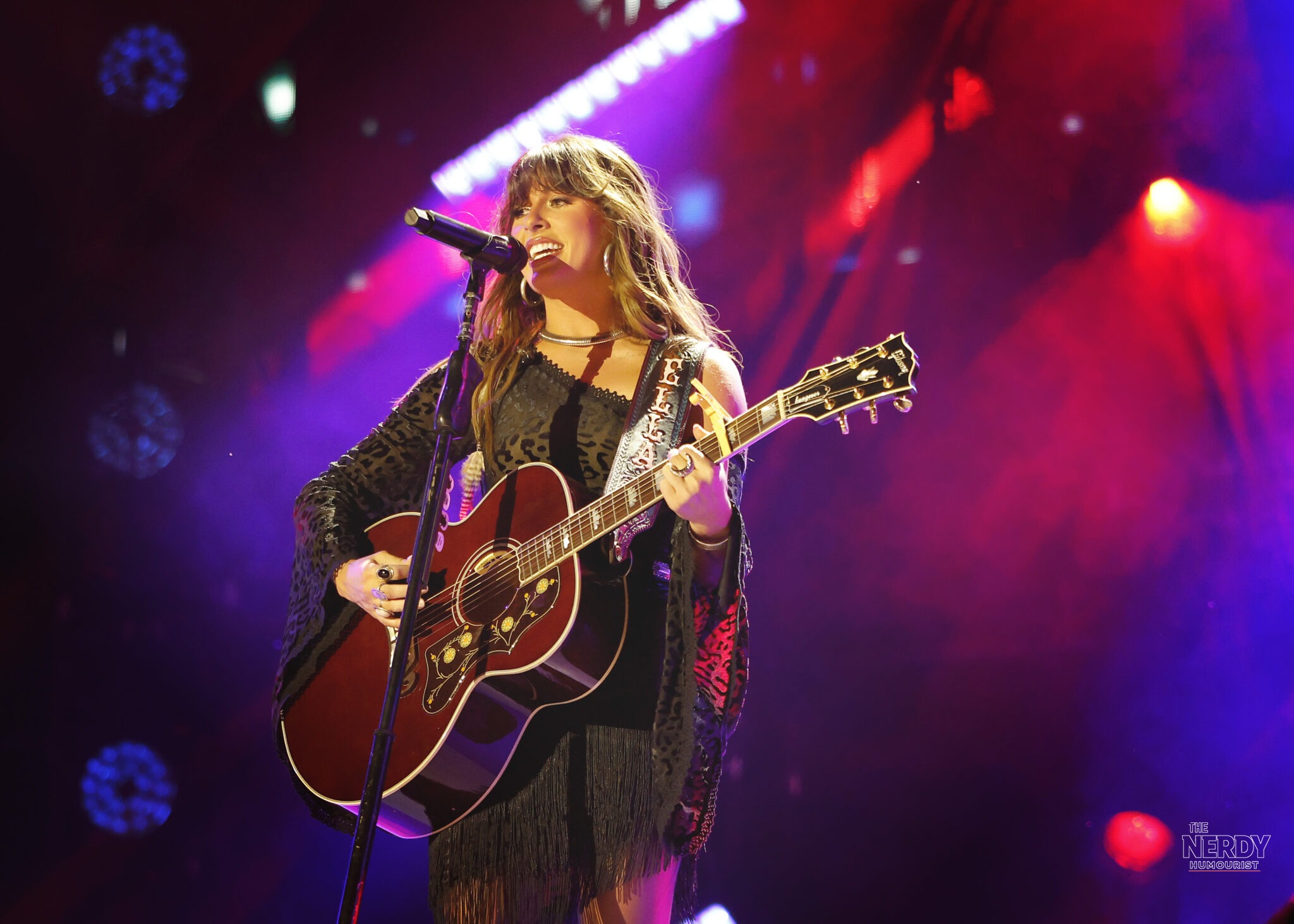 Ella Langley performing onstage with her guitar before the Ella Langley bomb threat concert cancellation in Tulsa