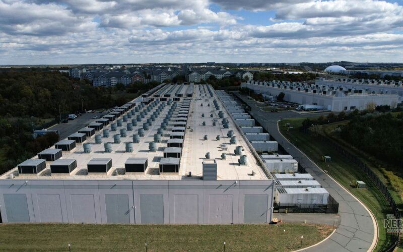 Aerial view of an Amazon data center campus set amid residential neighborhoods, the setting for Amazon's data center communities pledge