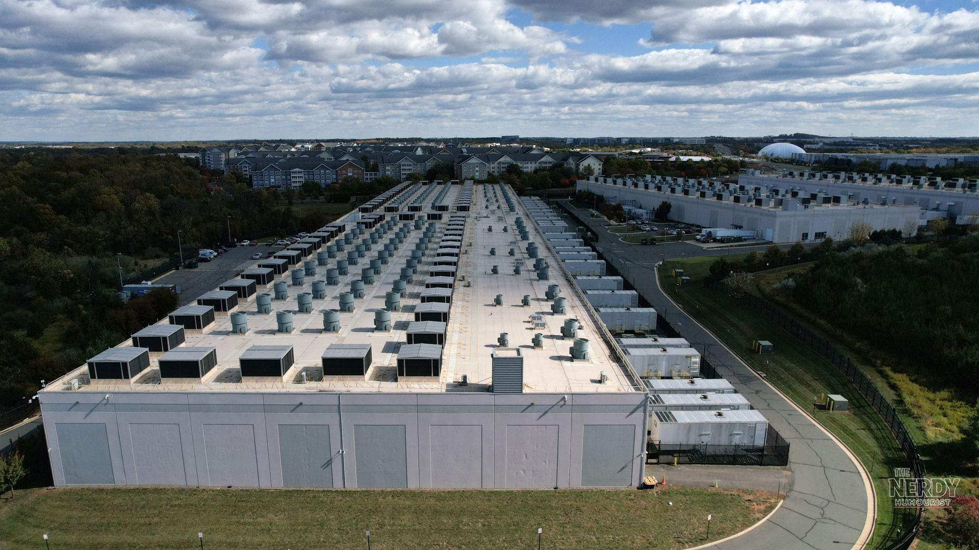 Aerial view of an Amazon data center campus set amid residential neighborhoods, the setting for Amazon's data center communities pledge