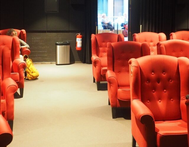 Cinema auditorium interior with red seats