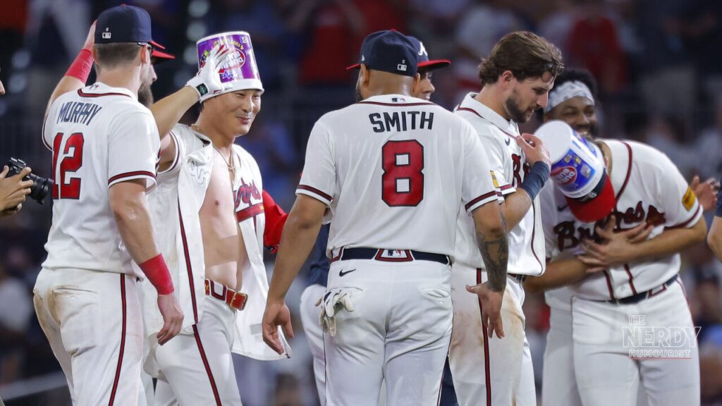 Atlanta Braves players mob Hyeseong Kim after his walk-off single earlier in the 2026 MLB playoffs
