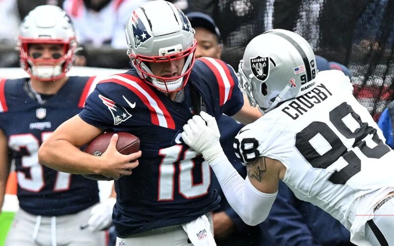 Drake Maye evades Raiders pass rusher Maxx Crosby during the Patriots' 45-17 win at Gillette Stadium