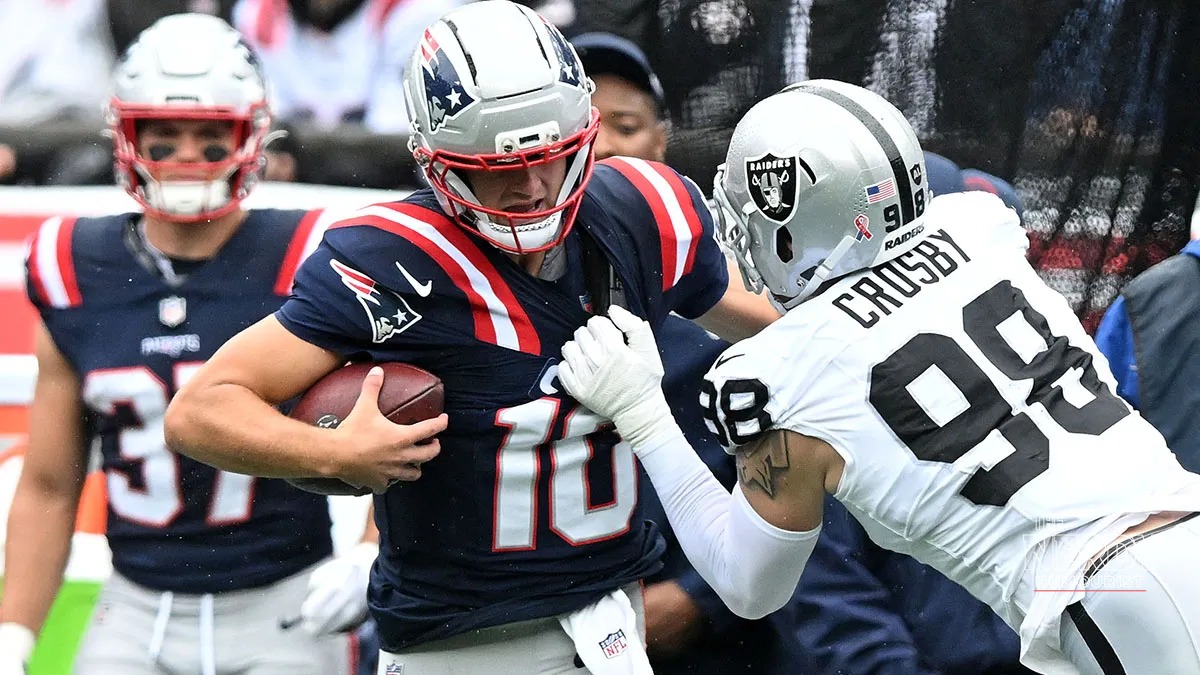 Drake Maye evades Raiders pass rusher Maxx Crosby during the Patriots' 45-17 win at Gillette Stadium