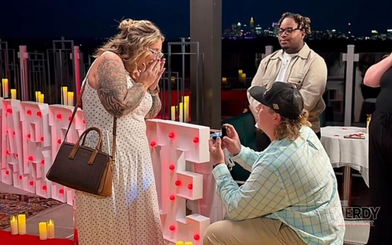 Darrin Kitchens on one knee proposing to Pumpkin engaged on an Atlanta rooftop