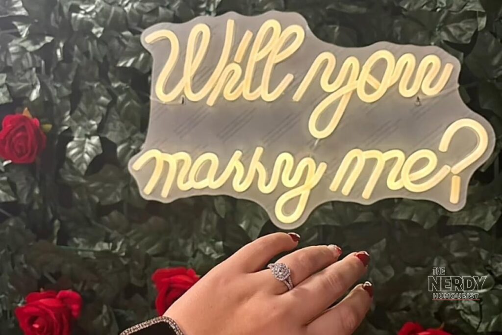 Pumpkin engaged — 'Will you marry me?' neon sign and her split-shank diamond ring