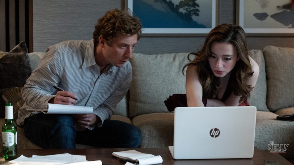 Jeremy Allen White and Mikey Madison study a laptop in a scene from The Social Reckoning movie