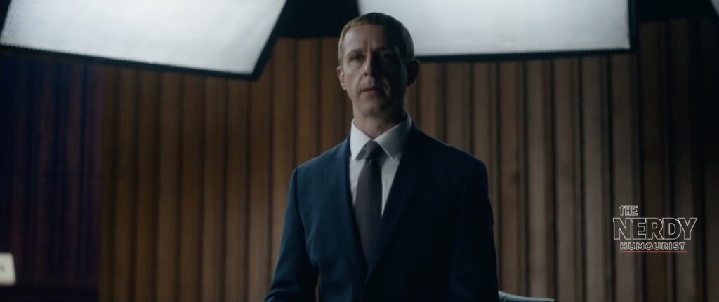 Jeremy Strong as Zuckerberg in The Social Reckoning movie, standing before wood panelling