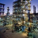 ExxonMobil refinery at dusk, illustrating the ExxonMobil Q3 earnings warning as the company guides Q3 2026 earnings lower