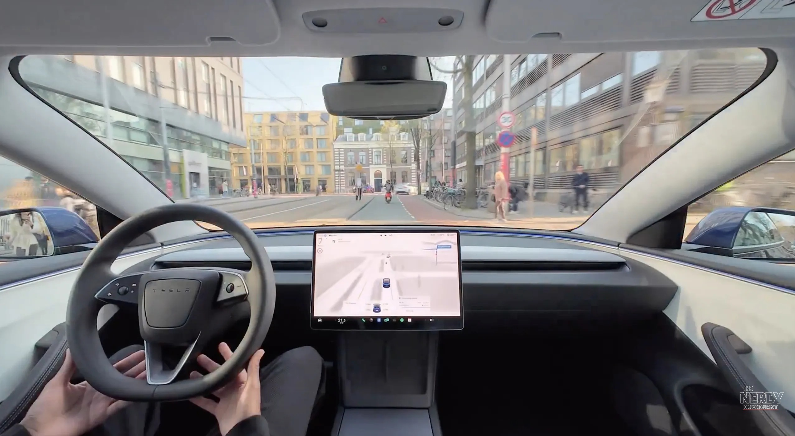 A Tesla driving hands-free on a European street — Tesla FSD EU approval would unlock the system across the bloc