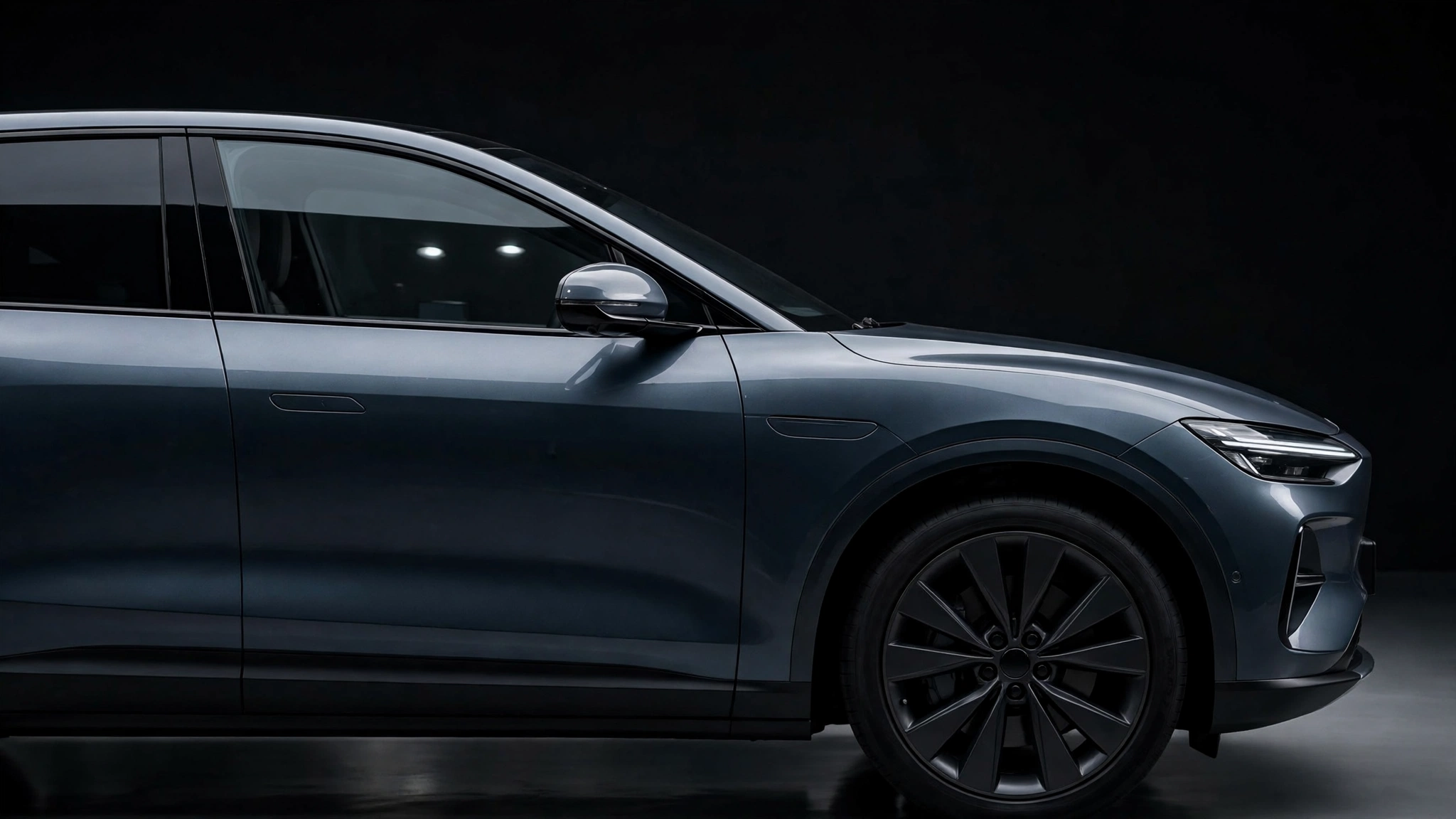 Modern luxury electric SUV side profile showing the front side window area for the Cadillac Optiq recall story
