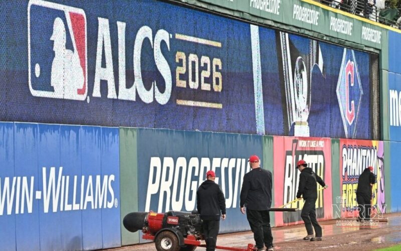 Grounds crew working the soaked warning track at Progressive Field after ALCS Game 4 was postponed by rain
