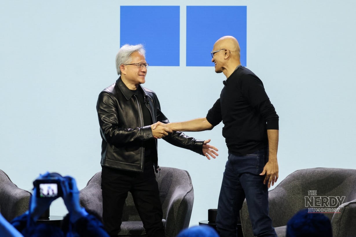Microsoft CEO Satya Nadella and Nvidia CEO Jensen Huang shake hands on stage at the Surface Laptop Ultra price reveal event