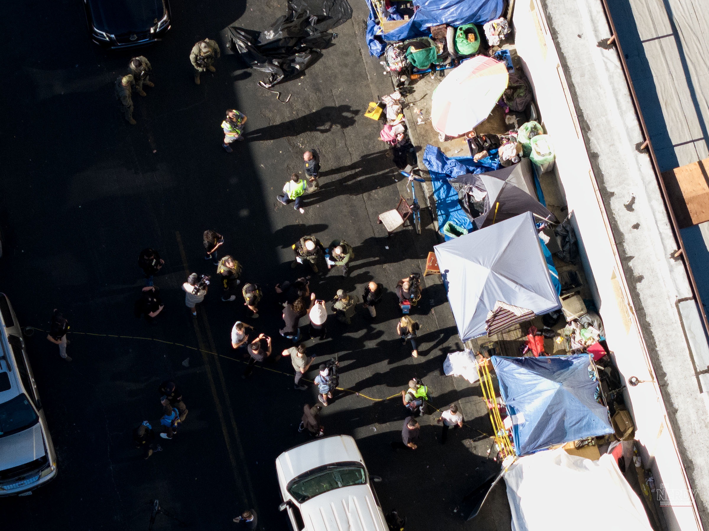 A drone view of agents and media gathered over Skid Row tents during the Operation Free Skid Row multi-agency raid in downtown Los Angeles.