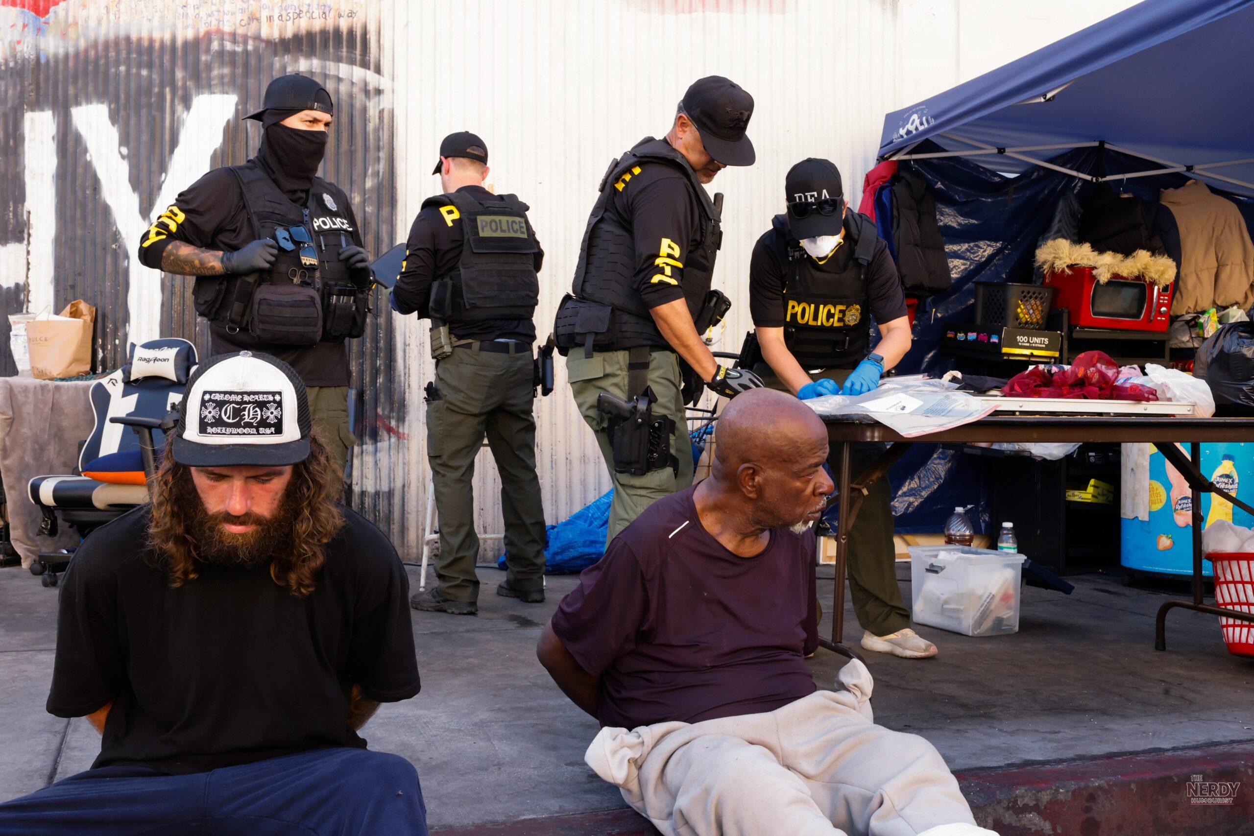 Federal agents from the DEA, LAPD and other agencies search a Skid Row storefront and tent setup during Operation Free Skid Row on Oct 8, 2026, in Los Angeles.
