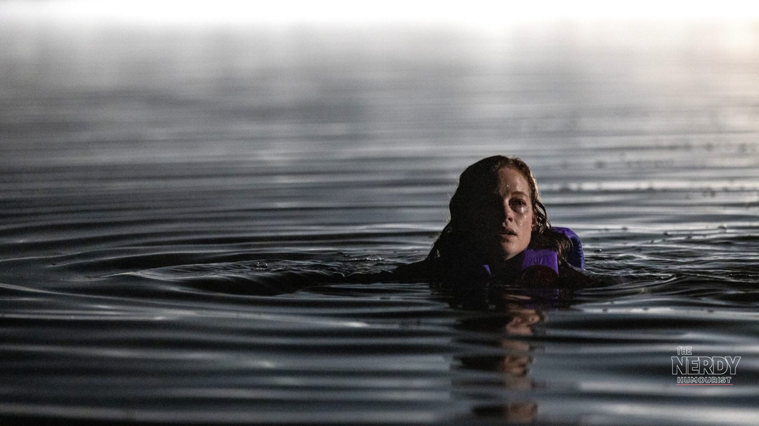 Jane Levy in an official still from the River trailer, treading water at night in the Blumhouse slasher