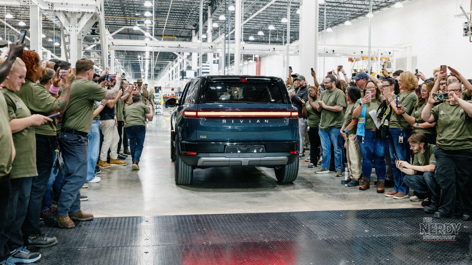First production Rivian R2 rolling off the line at the Normal factory in Illinois, relevant to the Rivian R2 second recall fastener manufacturing issue