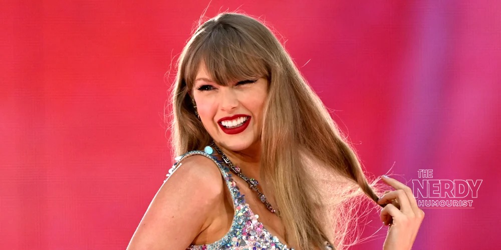 Taylor Swift smiling in a sequined outfit at the 2026 iHeartRadio Music Awards — Patient Zero is her 16th Billboard Hot 100 No. 1