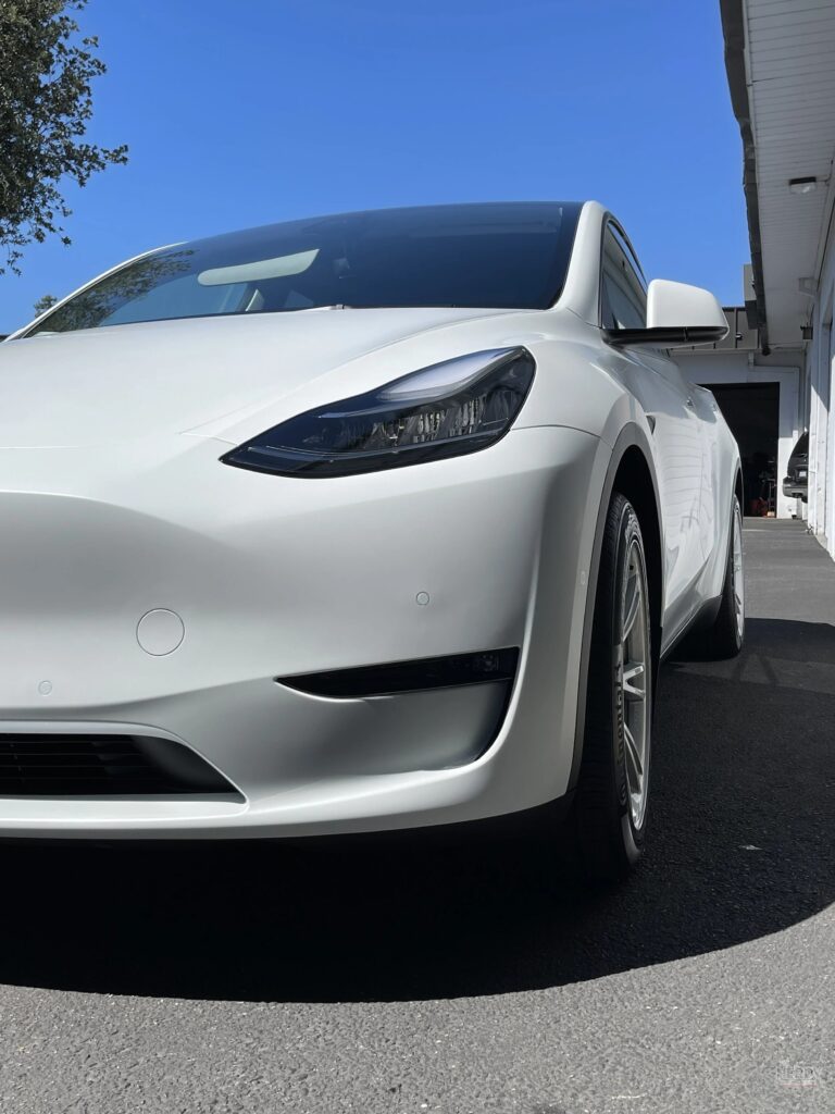 A white Tesla Model Y in close-up — Tesla Q3 deliveries 2026 were led by the Model Y, which made up 98% of deliveries together with the Model 3