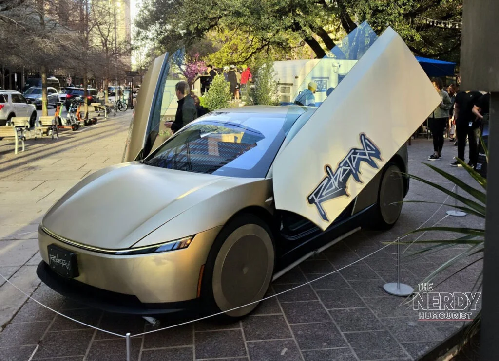 Tesla Cybercab robotaxi with butterfly doors open at the Austin launch event