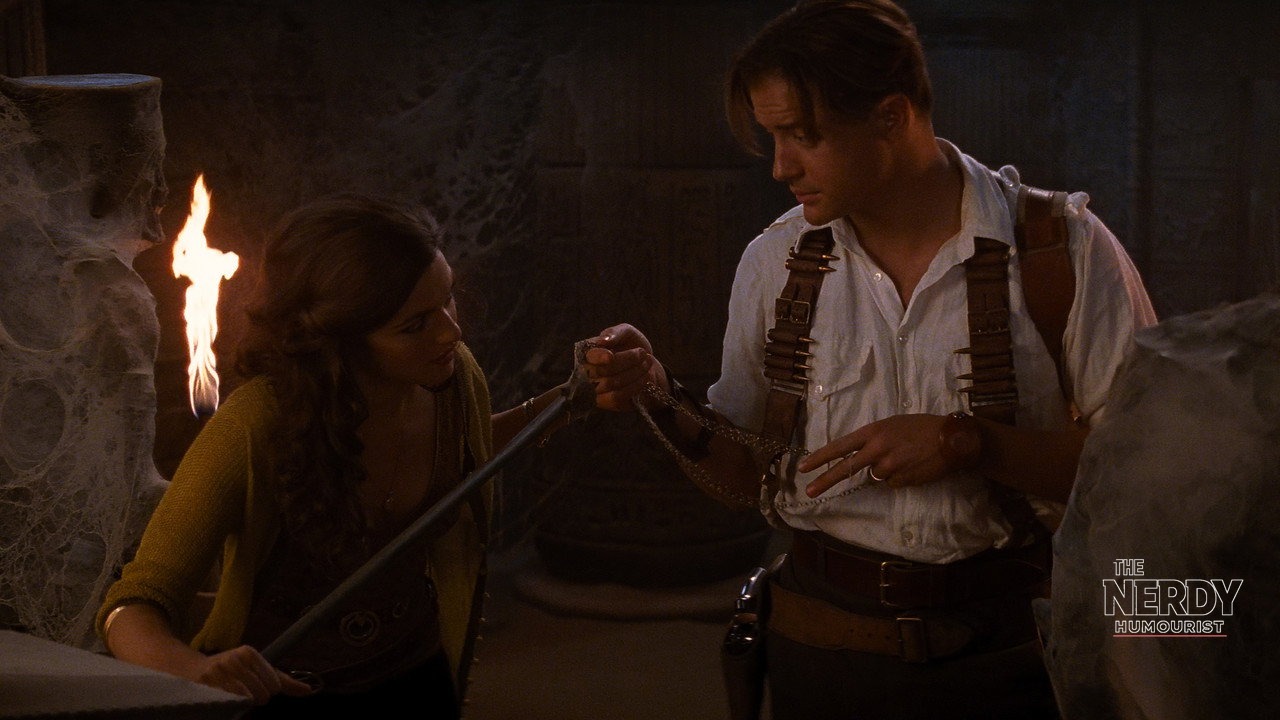 Brendan Fraser and Rachel Weisz exploring a torch-lit tomb in The Mummy, ahead of their return