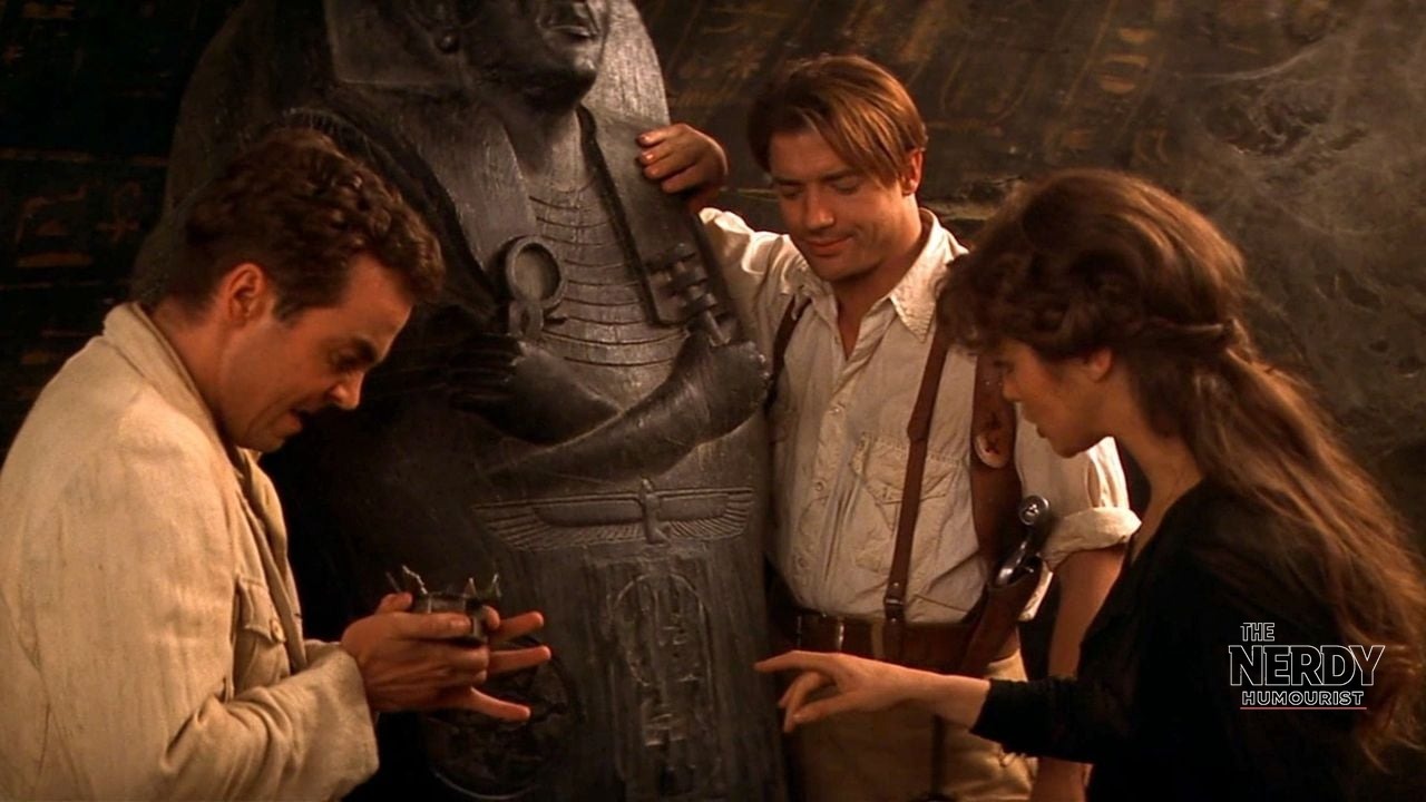 Brendan Fraser, Rachel Weisz, and John Hannah examining a sarcophagus in The Mummy (1999)