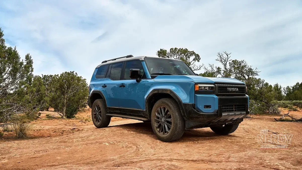 Blue 2025 Toyota Land Cruiser Hybrid SUV parked on desert trail, recalled over fuel leak fire risk