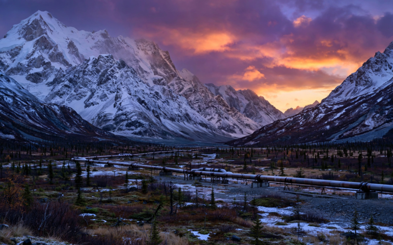 Alaskan mountain valley with gas pipeline at dusk illustrating South Korea US investment Alaska LNG deal