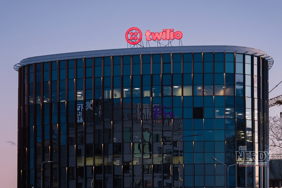 Twilio S&P 500 Warner Bros Discovery: a Twilio office building at dusk with the company logo