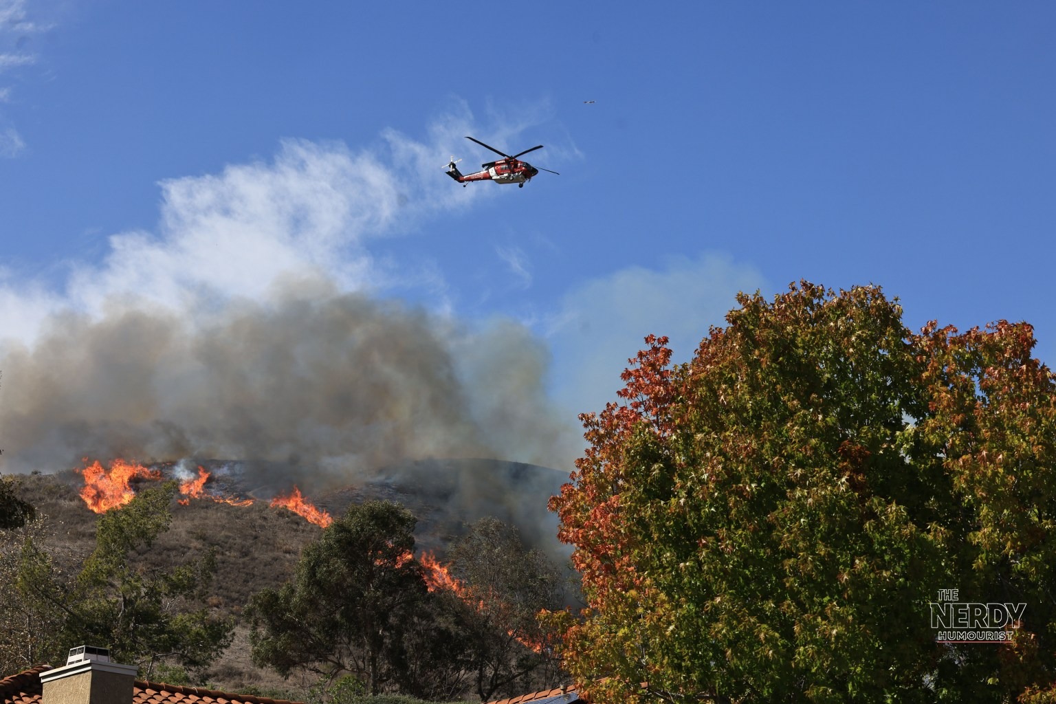 Norte Fire helicopter drops water over San Clemente hillside
